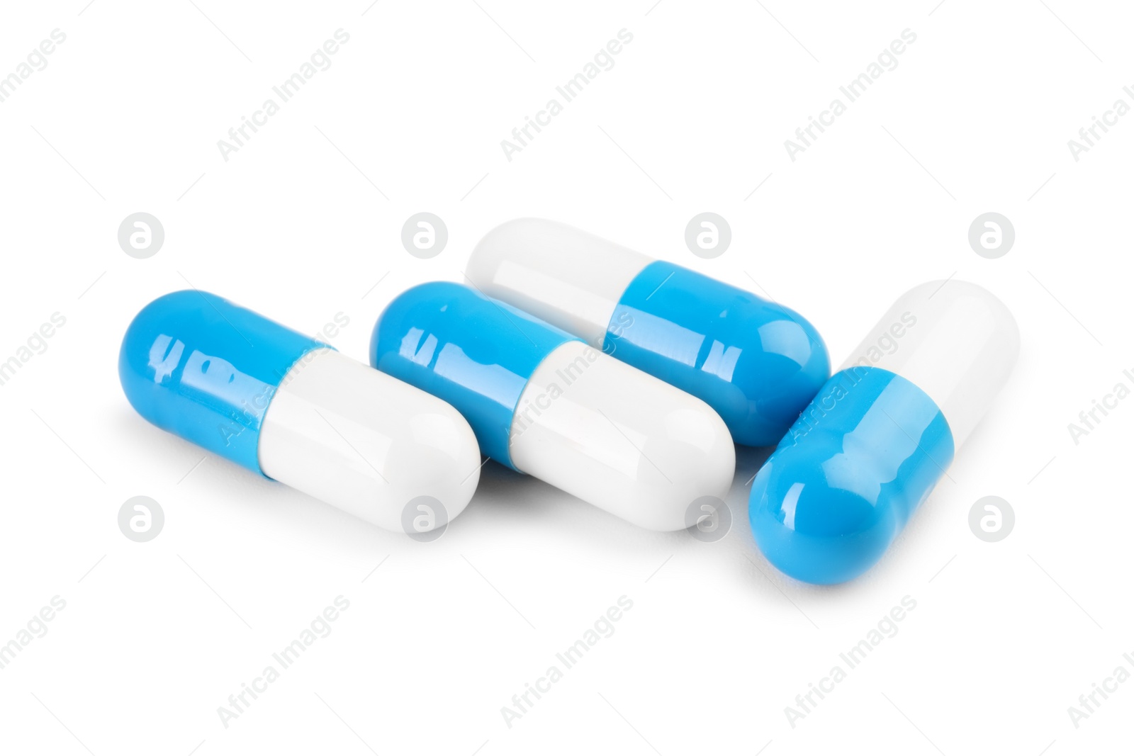 Photo of Antibiotic pills isolated on white. Medicinal treatment