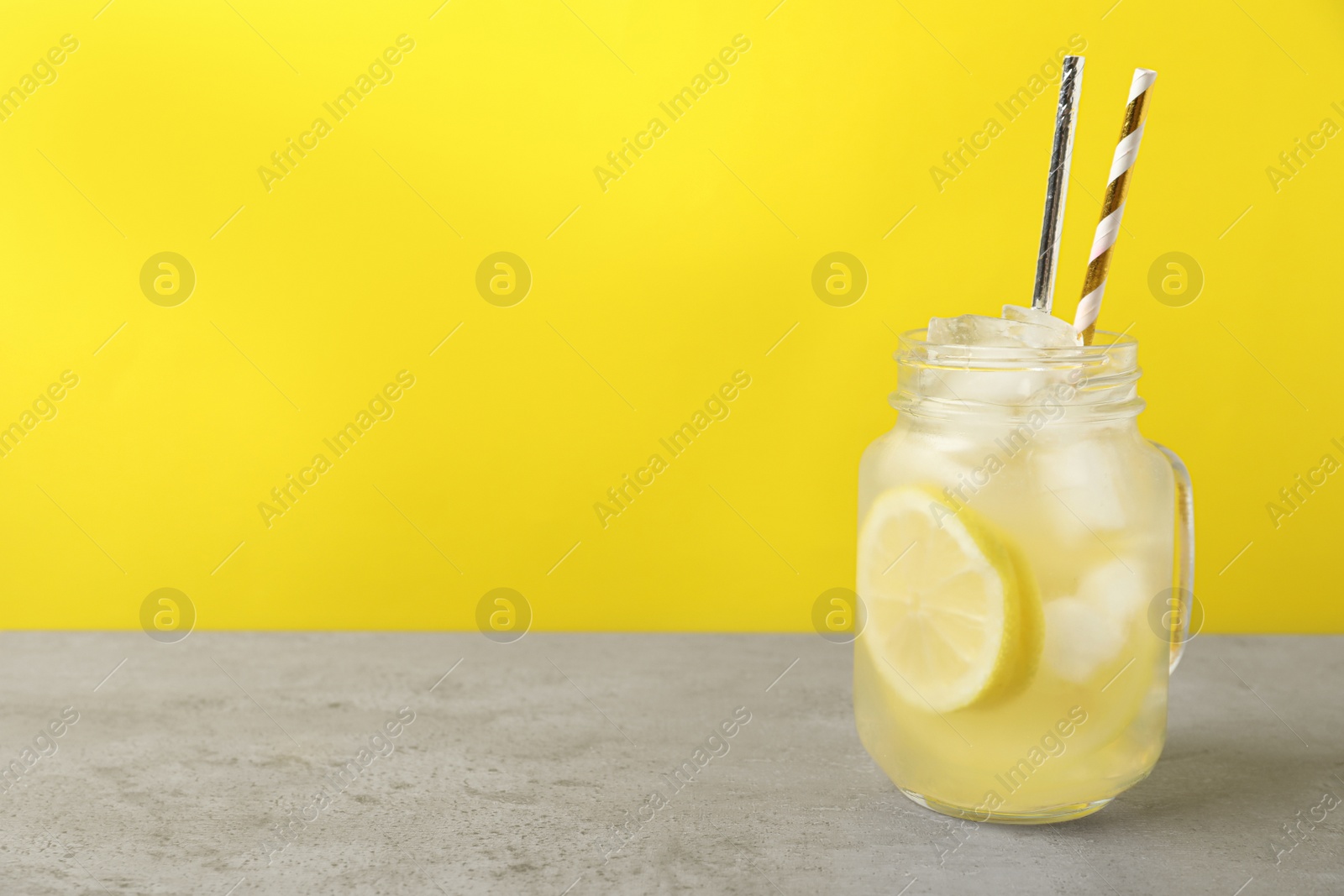 Photo of Natural lemonade on light grey table, space for text. Summer refreshing drink