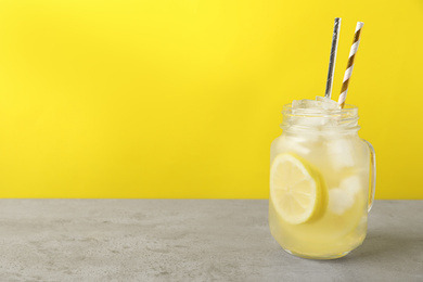 Natural lemonade on light grey table, space for text. Summer refreshing drink