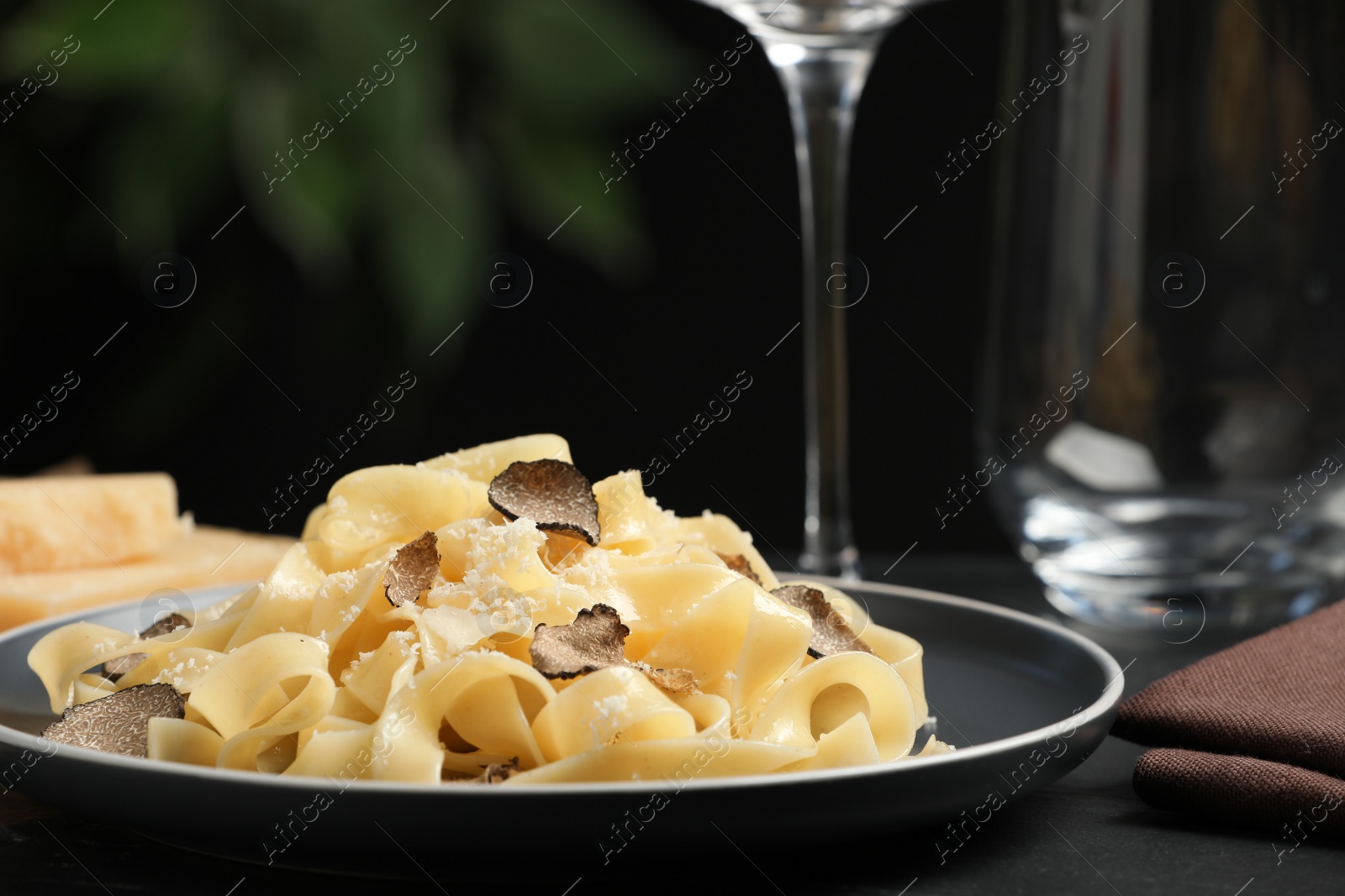 Photo of Tasty tagliatelle with truffle on black table