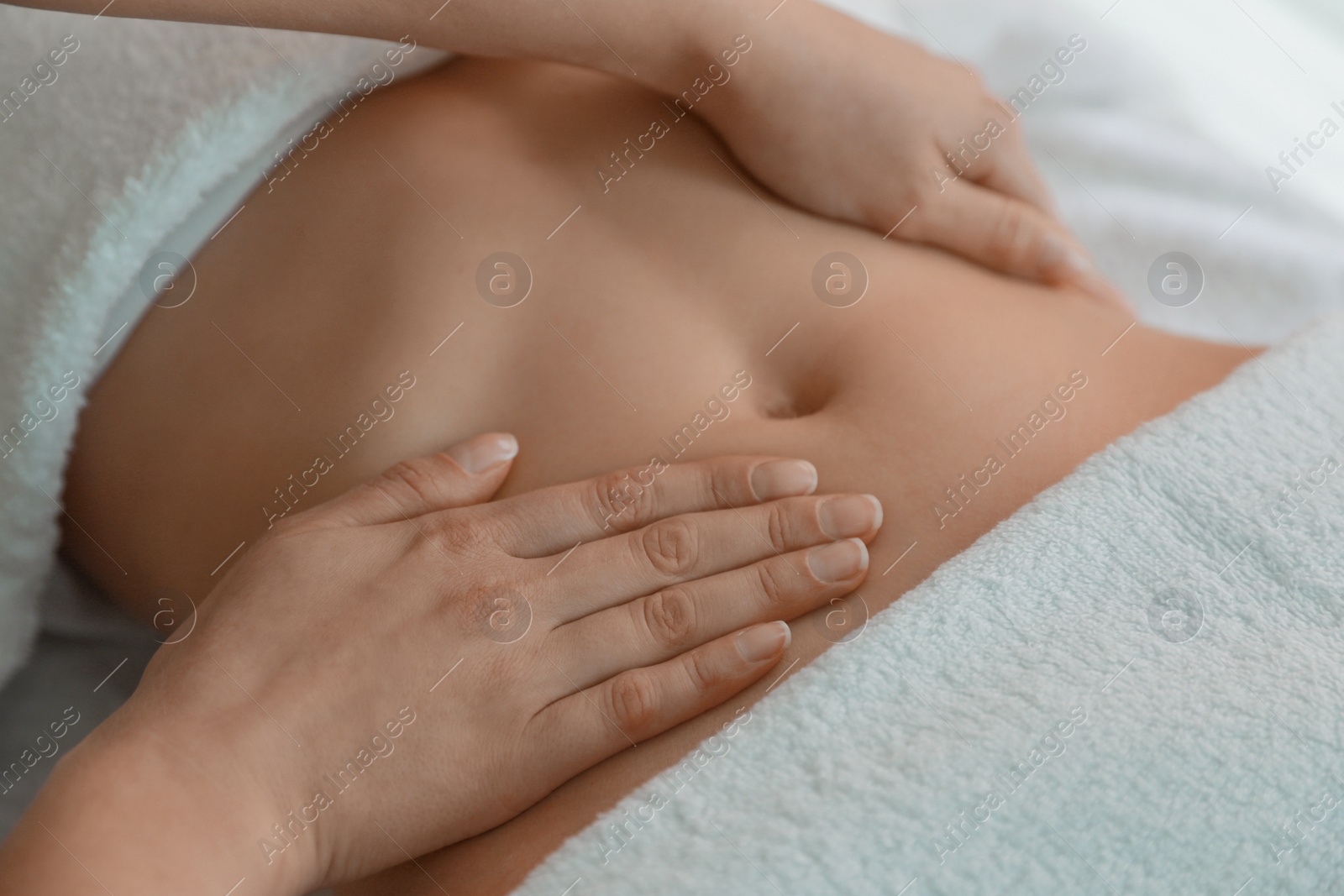 Photo of Woman receiving professional belly massage, closeup view