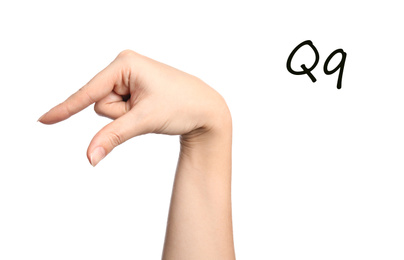 Woman showing letter Q on white background, closeup. Sign language