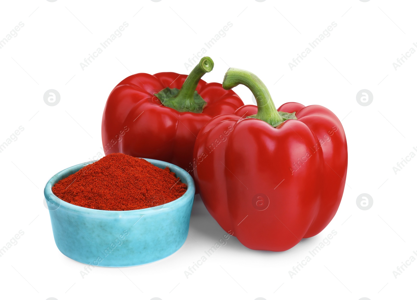 Photo of Bowl with aromatic paprika powder and fresh bell peppers isolated on white