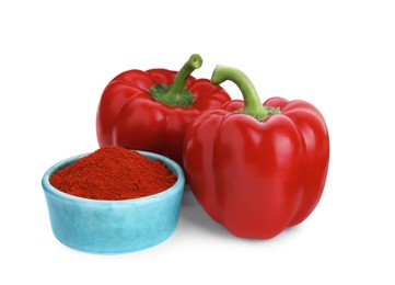 Photo of Bowl with aromatic paprika powder and fresh bell peppers isolated on white