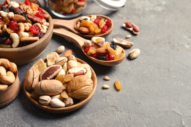 Photo of Composition of different dried fruits and nuts on color background. Space for text
