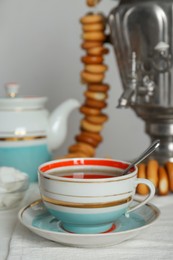 Composition with delicious ring shaped Sushki (dry bagels) and tea on white wooden table indoors