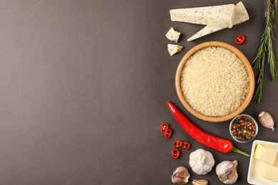 Photo of Flat lay composition with different ingredients on grey background, space for text. Risotto recipe