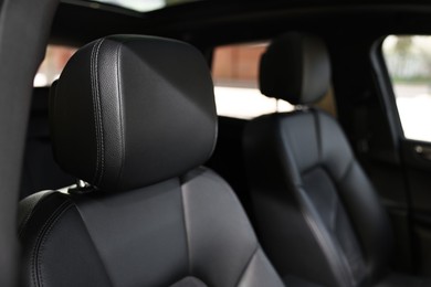 Seats inside of modern black car, closeup view