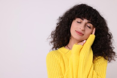 Photo of Young woman in stylish yellow sweater on white background, space for text