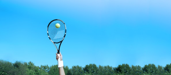 Image of Sportswoman playing tennis outdoors on sunny day, closeup. Banner design with space for text