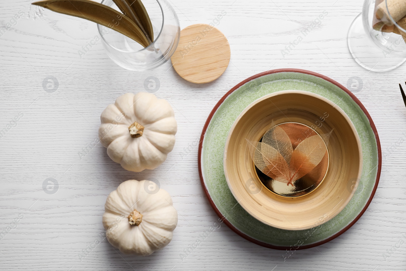 Photo of Autumn table setting with pumpkins on white wooden background, flat lay