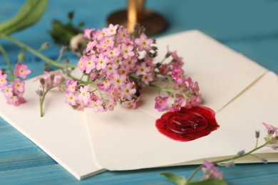 Composition with beautiful Forget-me-not flowers on light blue wooden table, closeup