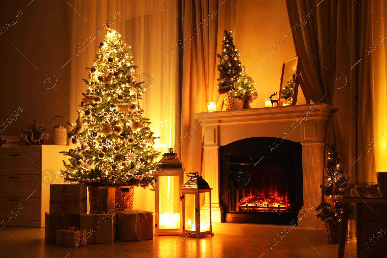 Photo of Stylish living room interior with beautiful fireplace, Christmas tree and other decorations at night