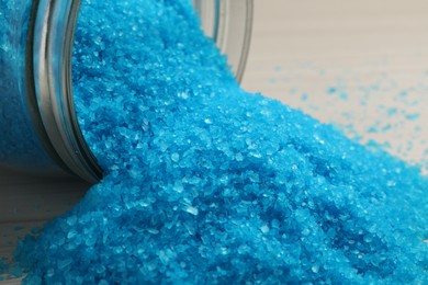 Photo of Aromatic sea salt on white wooden table, closeup