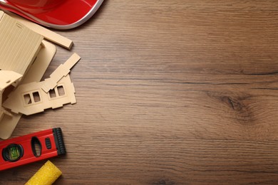 Photo of Flat lay composition with building level and other construction tools on wooden table, space for text