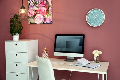 Photo of Stylish workplace interior with computer monitor on table