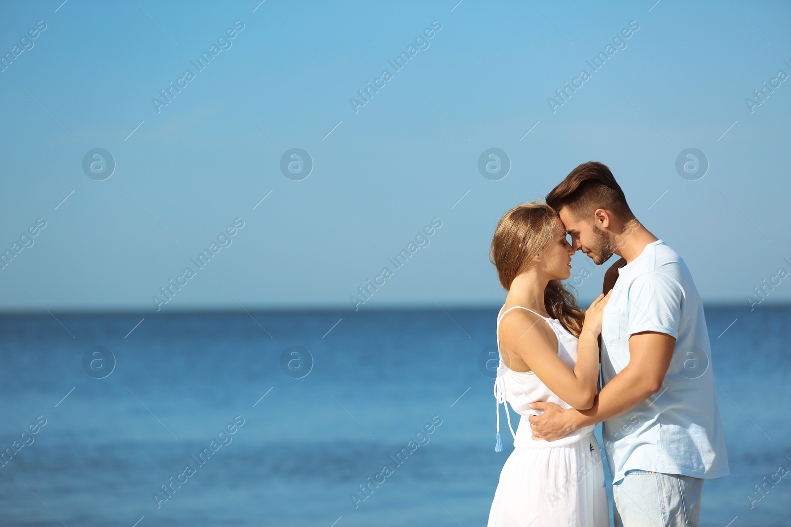 Photo of Happy young couple at beach on sunny day