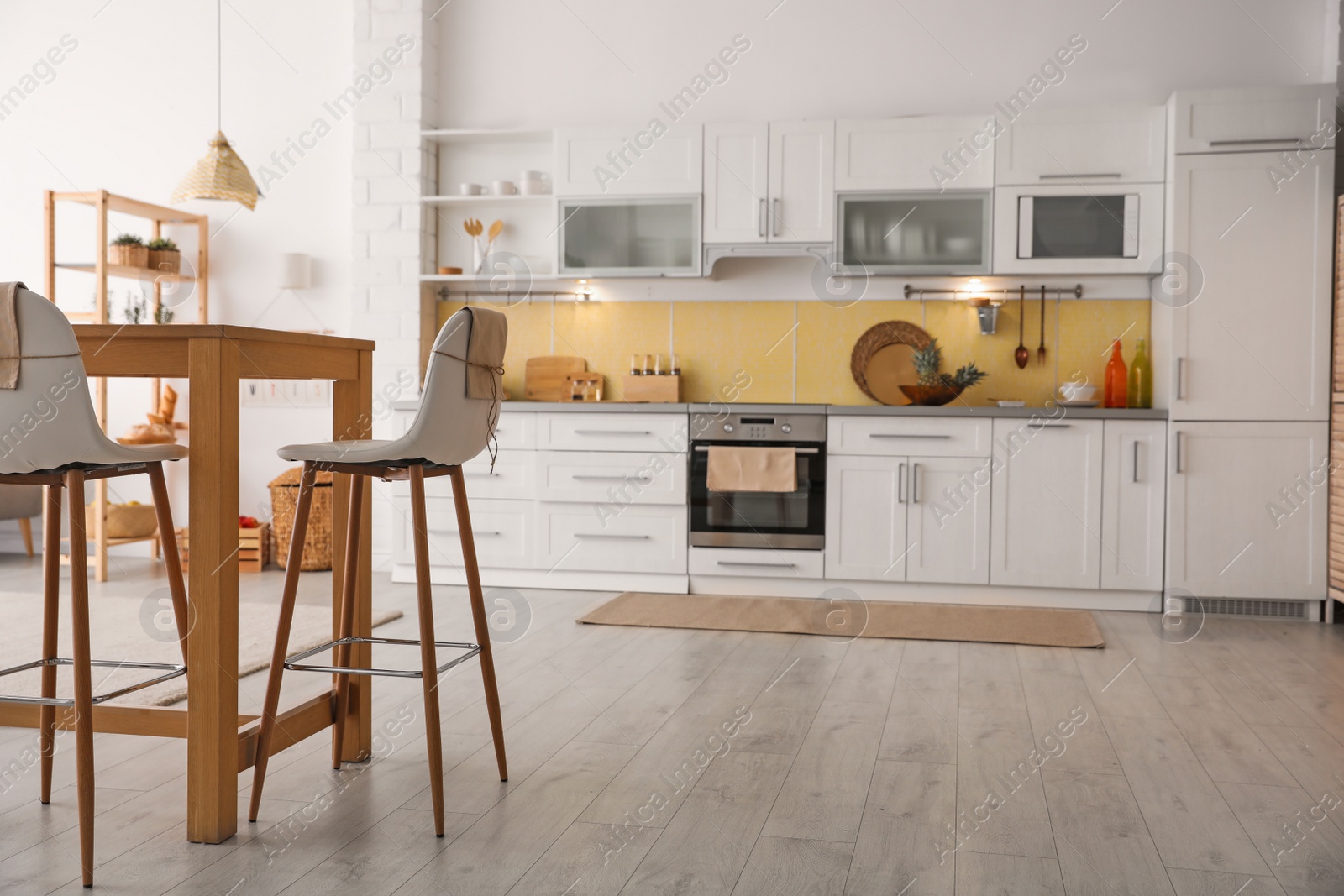 Photo of Modern kitchen interior with stylish wooden table