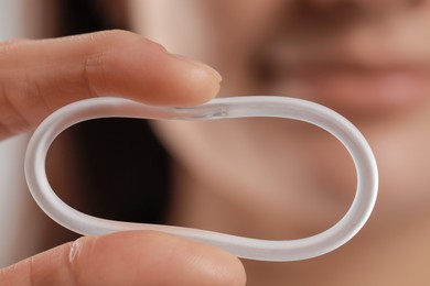 Photo of Woman holding diaphragm vaginal contraceptive ring, closeup