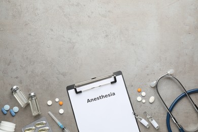 Flat lay composition of clipboard with word Anesthesia and drugs on grey table, space for text