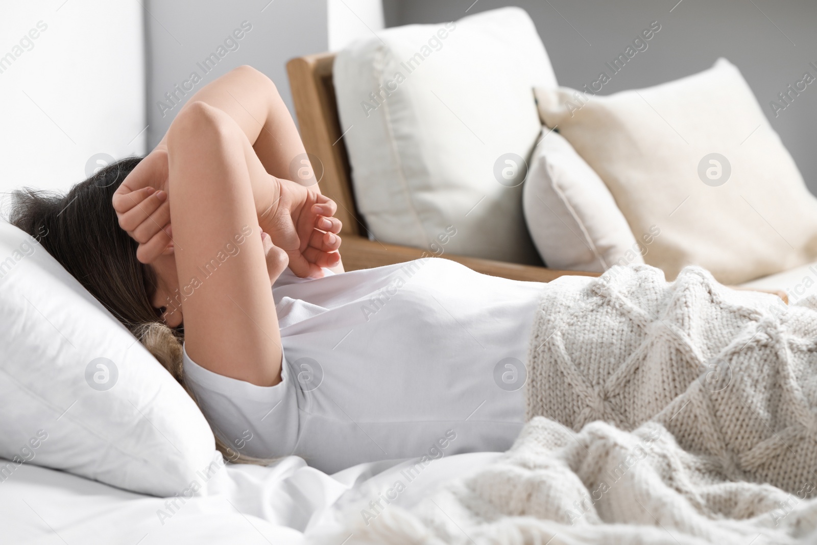 Photo of Sleepless young woman in bed at home