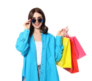 Beautiful young woman with paper shopping bags on white background