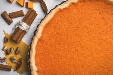 Delicious homemade pumpkin pie on white wooden table, closeup