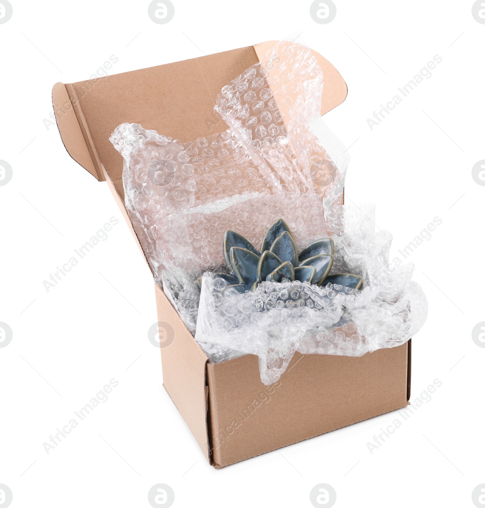 Photo of Ceramic decor item with bubble wrap in cardboard box isolated on white