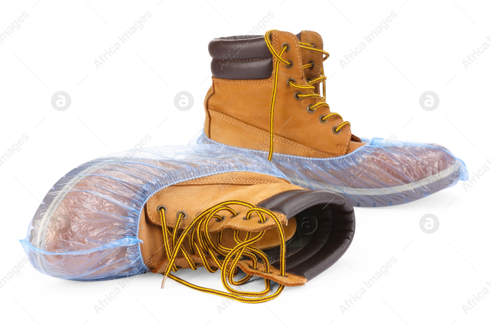 Photo of Boots in blue shoe covers isolated on white