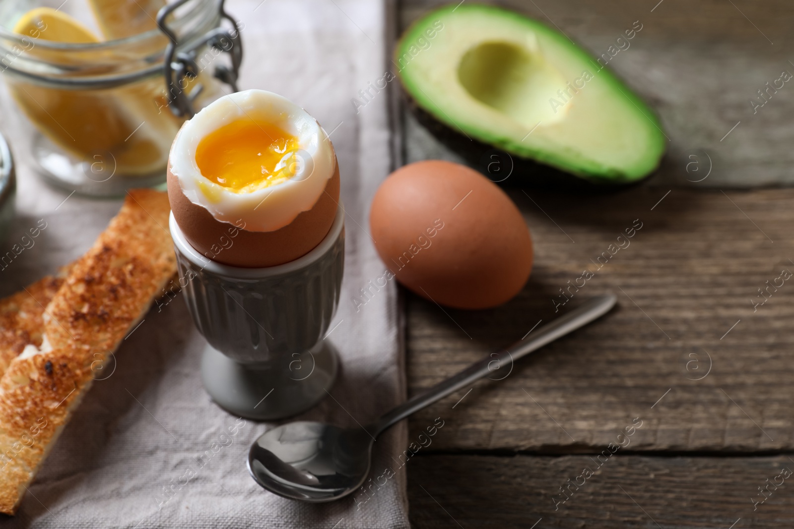 Photo of Soft boiled egg served for breakfast on wooden table