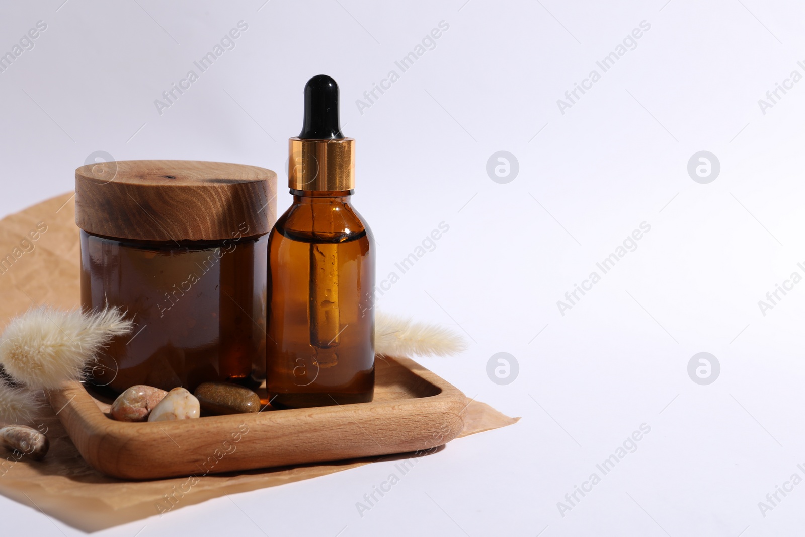 Photo of Composition with bottle of cosmetic serum on white background. Space for text