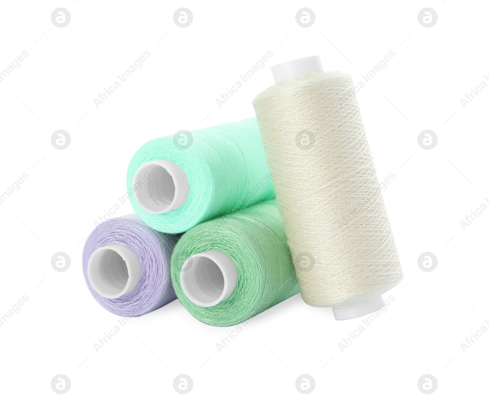 Photo of Different colorful sewing threads on white background