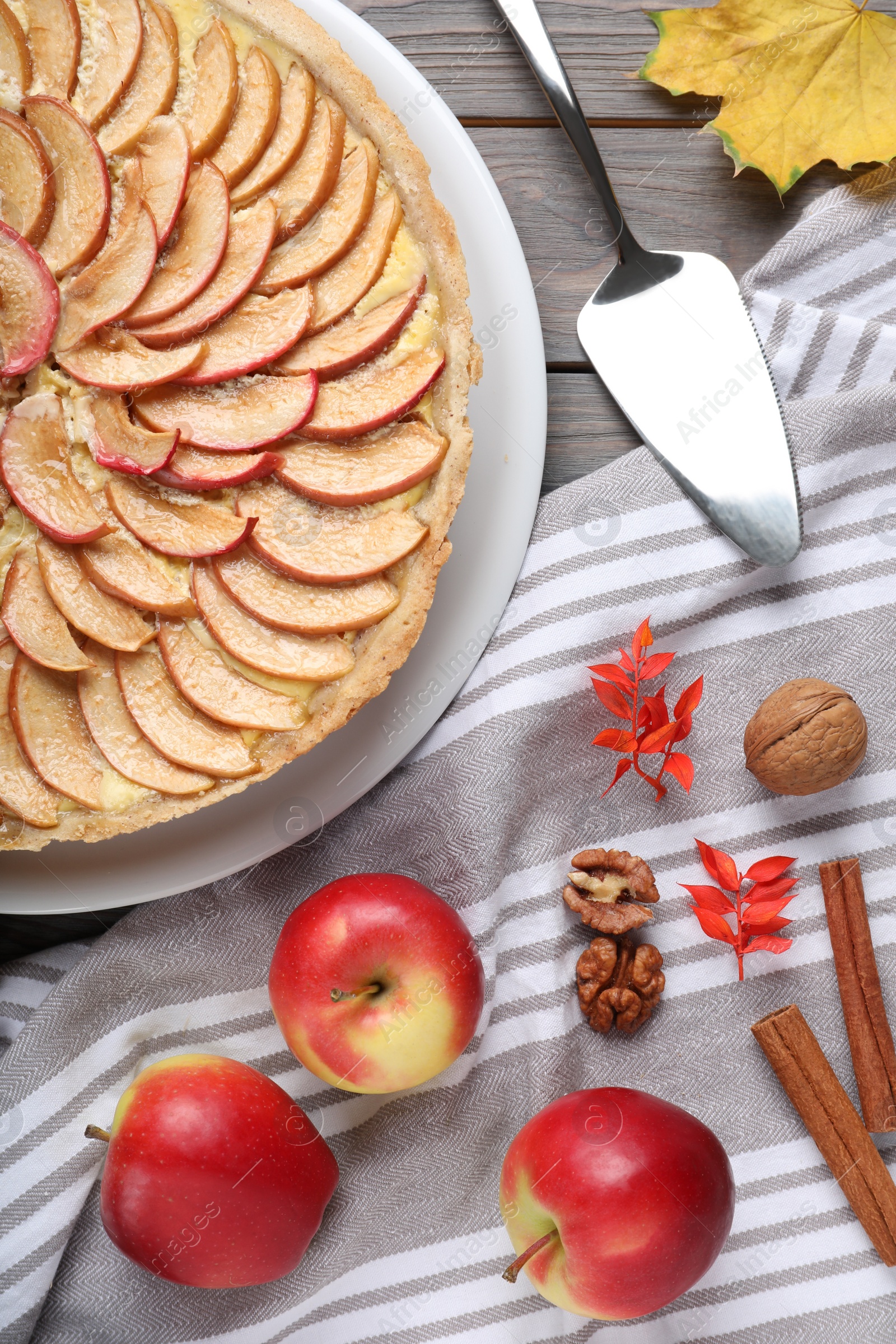 Photo of Flat lay composition with freshly baked delicious apple pie on wooden table