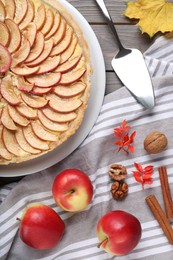 Flat lay composition with freshly baked delicious apple pie on wooden table