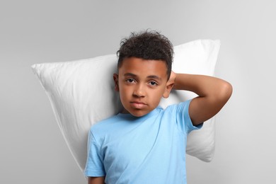 Photo of Boy with pillow on grey background. Insomnia problem
