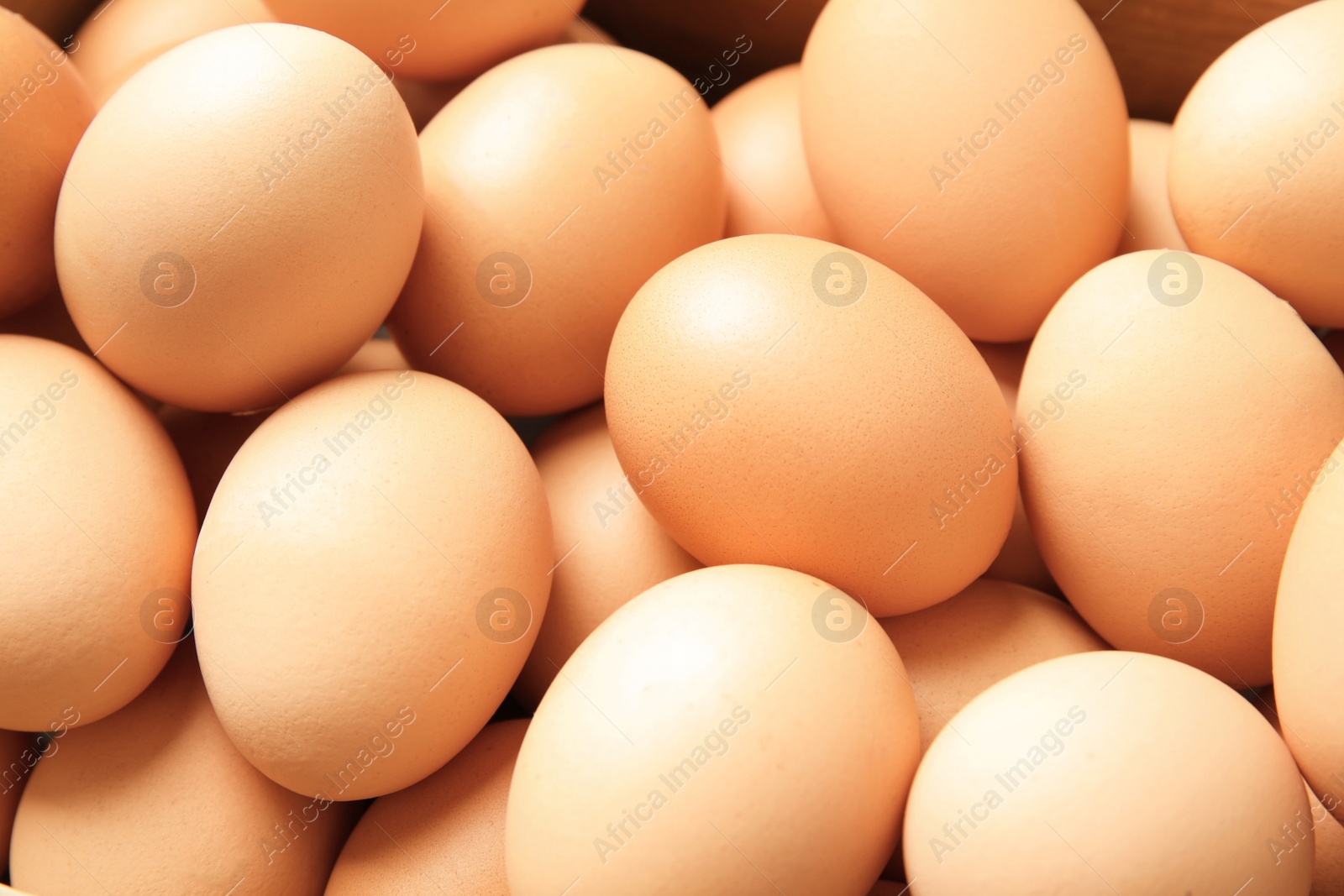 Photo of Pile of raw brown chicken eggs, closeup