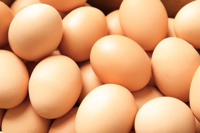 Photo of Pile of raw brown chicken eggs, closeup