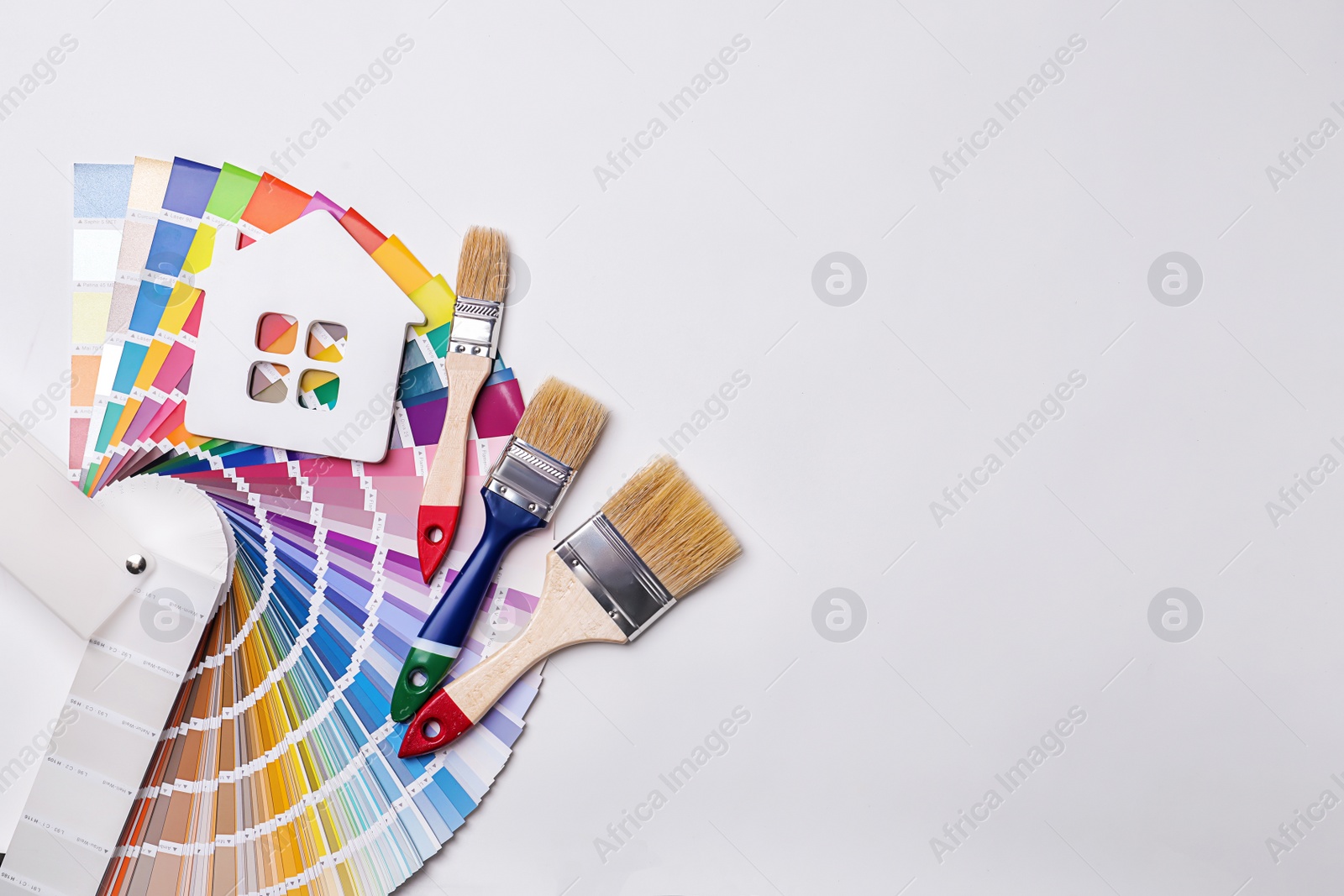 Photo of Set of decorator's tools on light background, flat lay