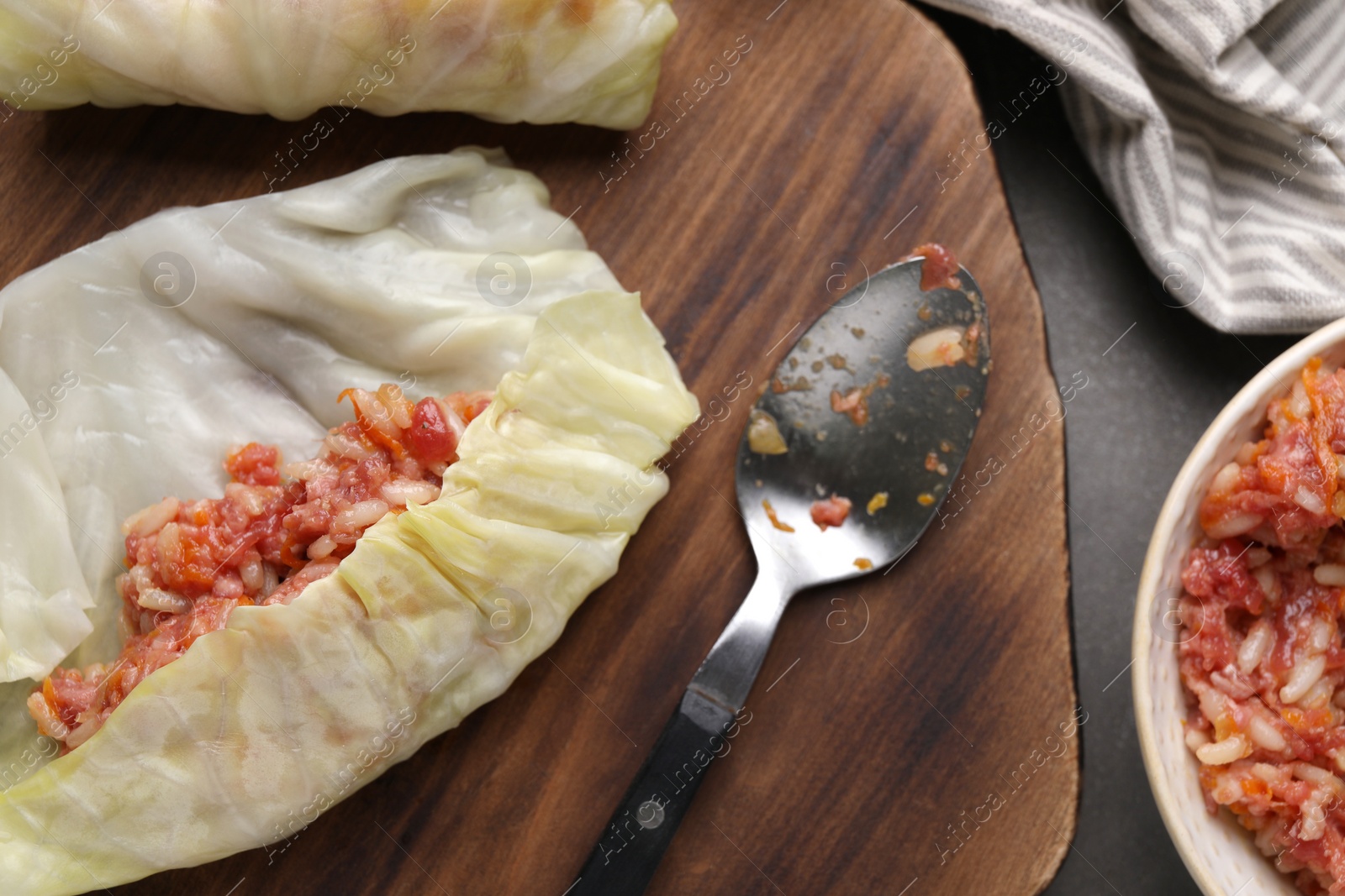 Photo of Preparing stuffed cabbage rolls on grey table, flat lay