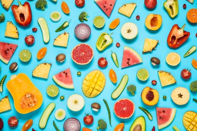 Flat lay composition with fresh organic fruits and vegetables on light blue background