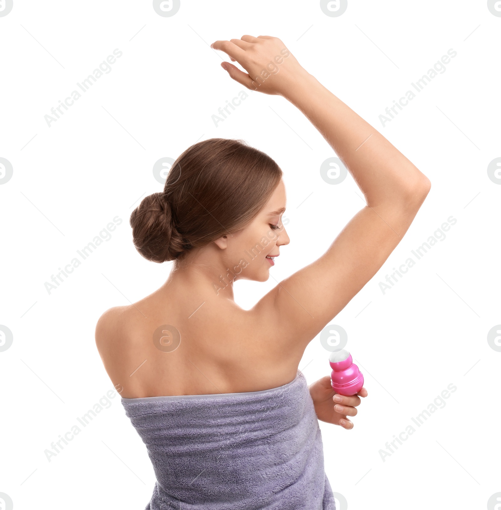 Photo of Young woman applying deodorant to armpit on white background