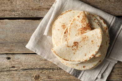 Photo of Tasty homemade tortillas on wooden table, top view