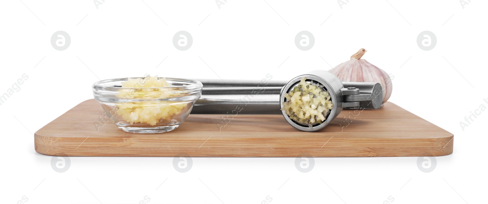 Photo of Board with one metal press and garlic isolated on white