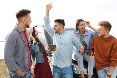 Group of happy people spending time together outdoors