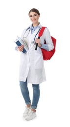 Young medical student with books and backpack on white background