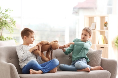 Photo of Brother arguing with sister on sofa at home
