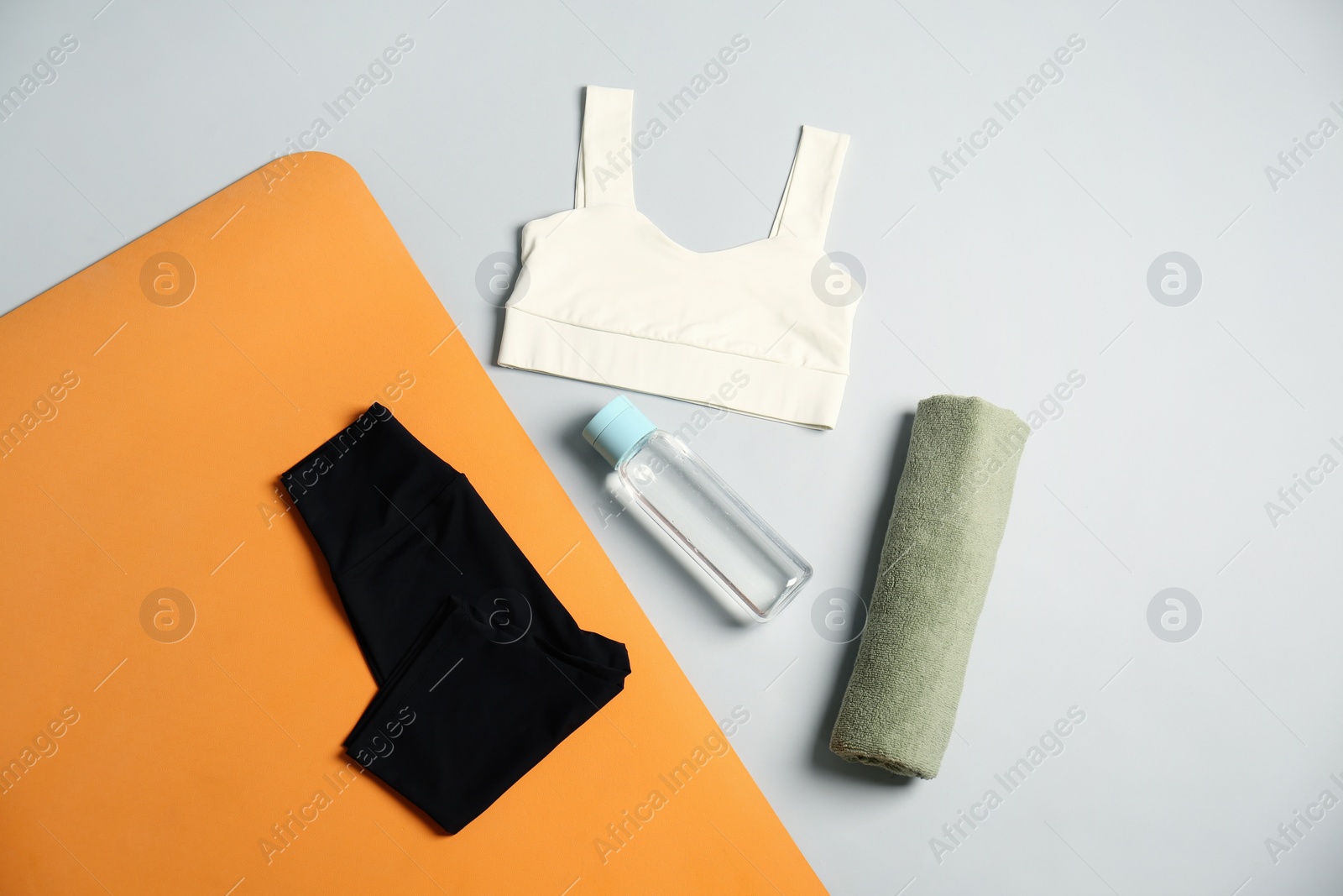 Photo of Flat lay composition with yoga equipment on grey background