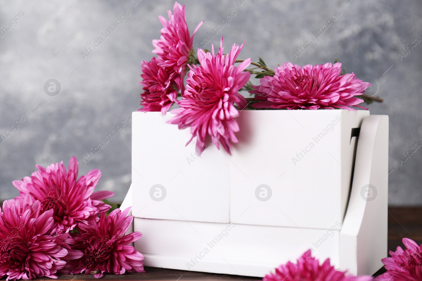 Photo of Thanksgiving day, holiday celebrated every fourth Thursday in November. Block calendar and beautiful chrysanthemums on wooden table, closeup