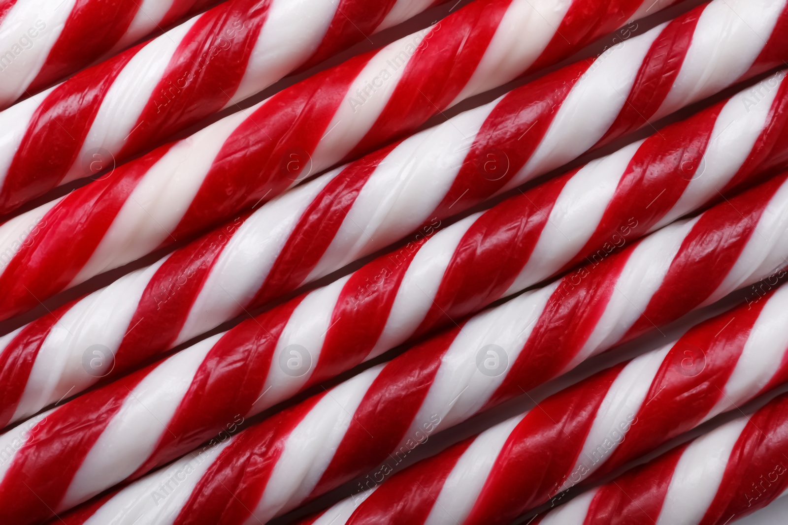 Photo of Top view of many sweet Christmas candy canes as background, closeup