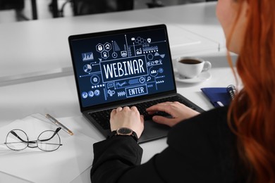 Online webinar, web page on computer screen. Woman using laptop at white table, closeup